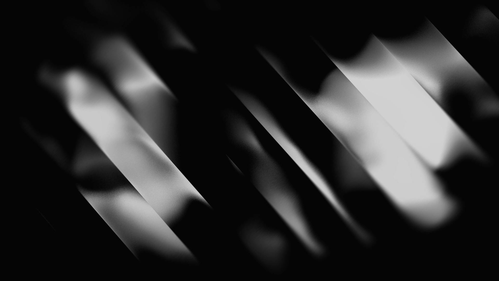 A series of diagonal black and white stripes with a smooth gradient effect. The alternating light and dark bands create a sense of depth and movement, resembling light rays or shadows cast across a surface. The overall aesthetic is abstract and high-contrast, with a sleek, modern feel.